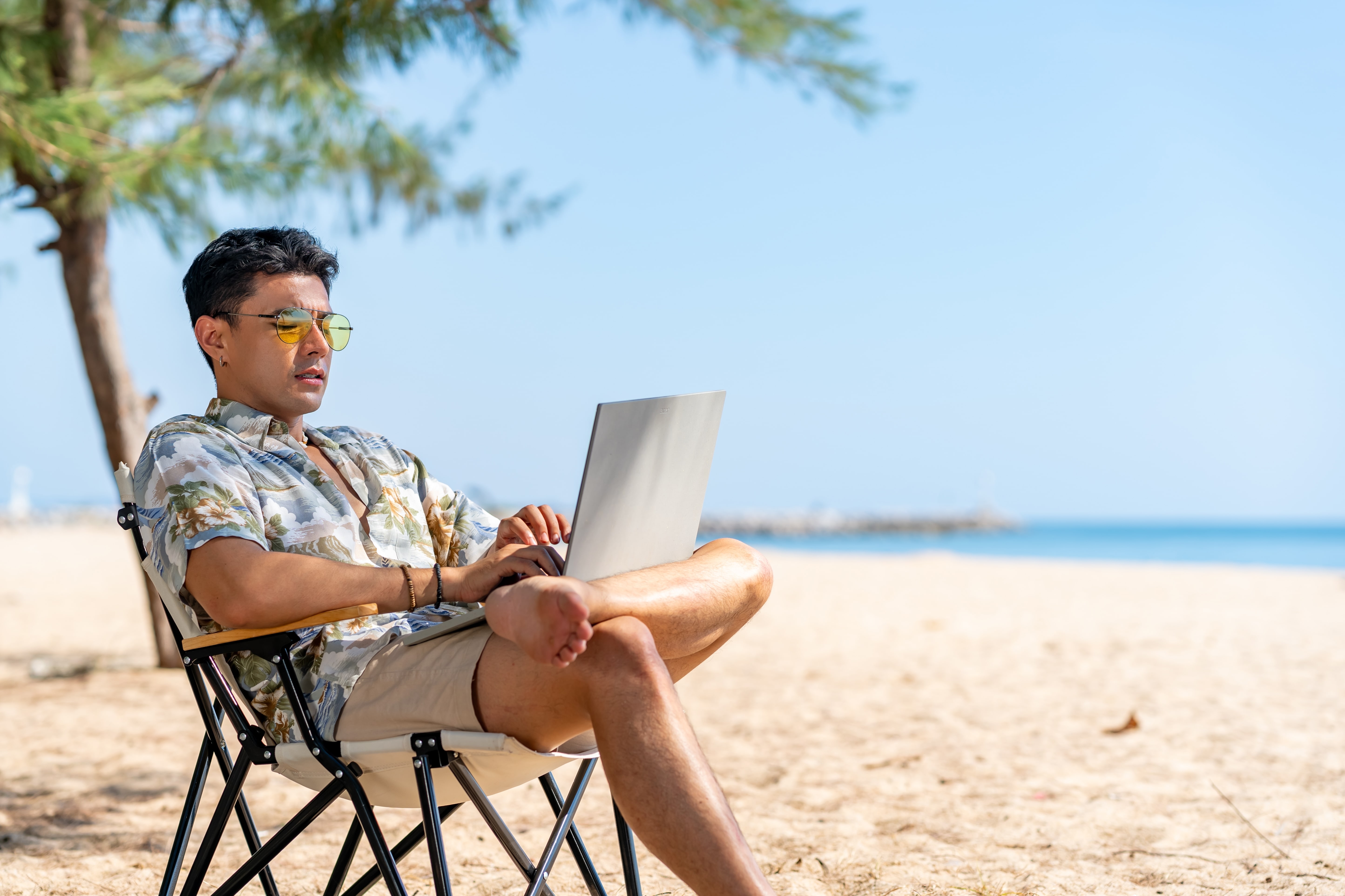 Digital nomad working on a beach